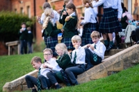 Description: Boys and girls breaktime on steps outdoors